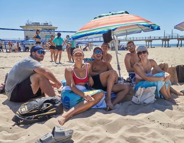 Players relaxing under beach umbrellas between matches