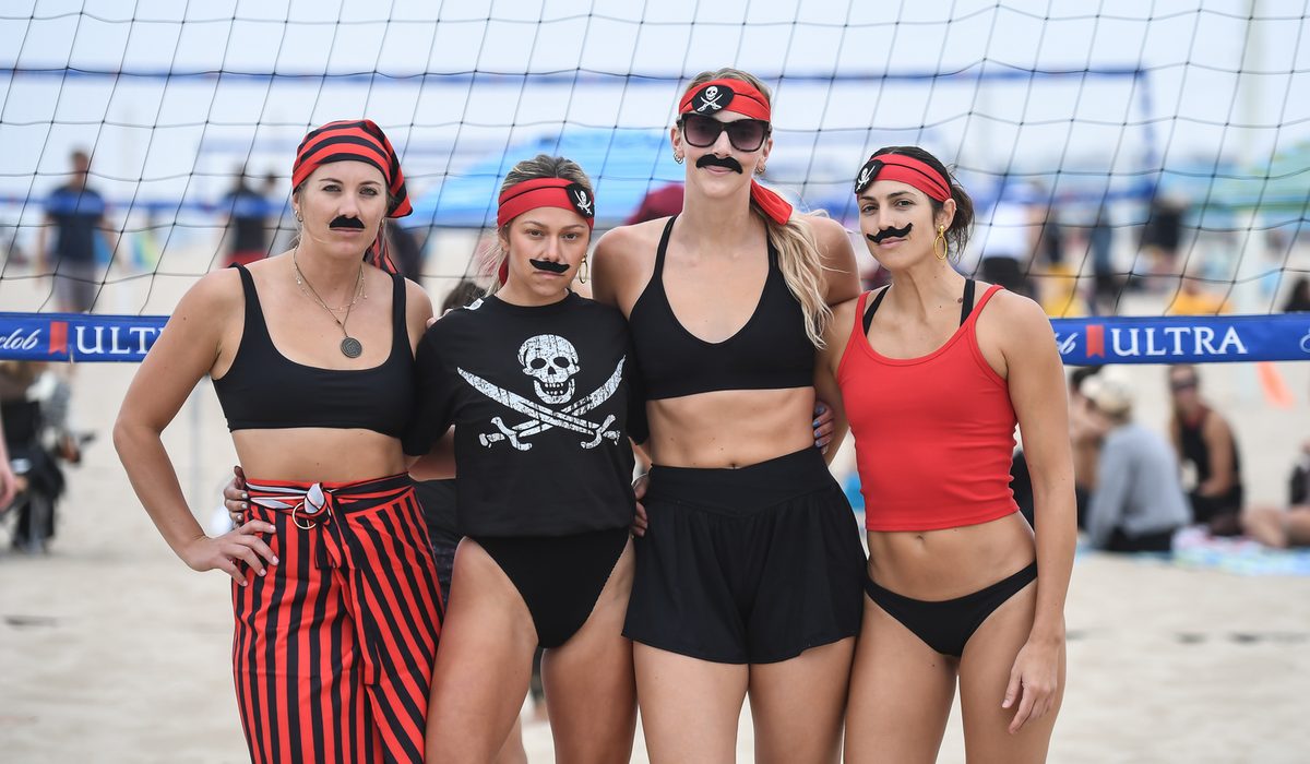 Players dressed as pirates with mustaches at the net